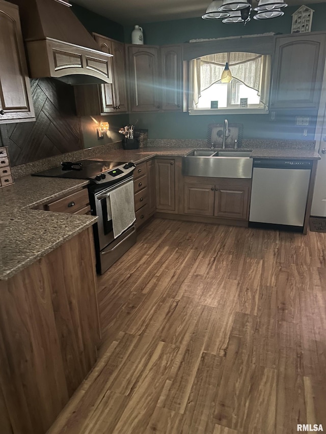 11382 Petroff Rd, Benton, IL 62812 - kitchen with appliances with stainless steel finishes, custom range hood, dark wood-style flooring, and dark stone counters