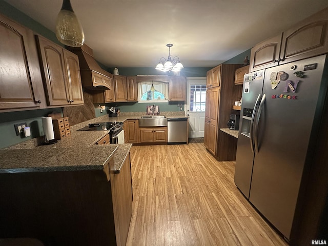 11382 Petroff Rd, Benton, IL 62812 - kitchen featuring appliances with stainless steel finishes, custom exhaust hood, light wood-type flooring, a chandelier, and a peninsula