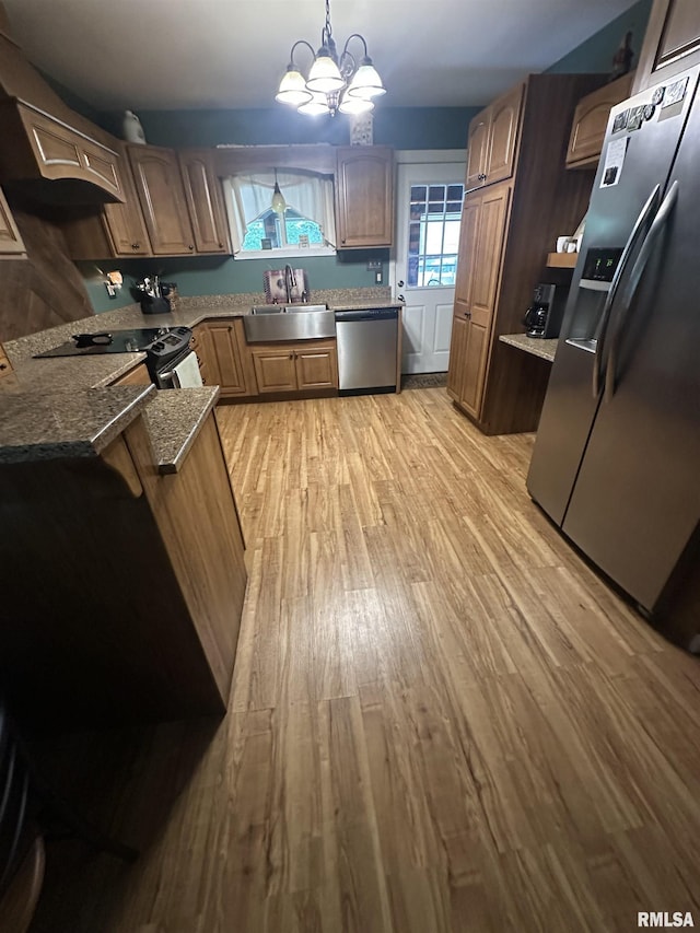 11382 Petroff Rd, Benton, IL 62812 - kitchen featuring appliances with stainless steel finishes, light wood finished floors, a chandelier, and dark stone countertops