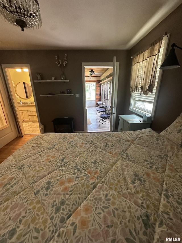 11382 Petroff Rd, Benton, IL 62812 - bedroom featuring access to outside, wood finished floors, and connected bathroom