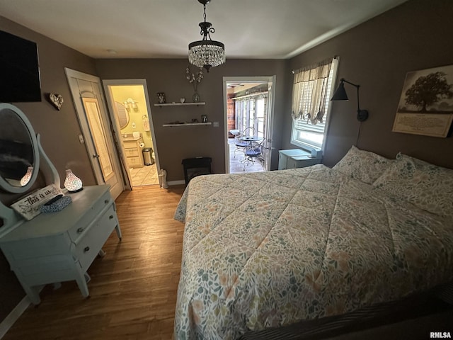 11382 Petroff Rd, Benton, IL 62812 - bedroom with wood finished floors and a chandelier