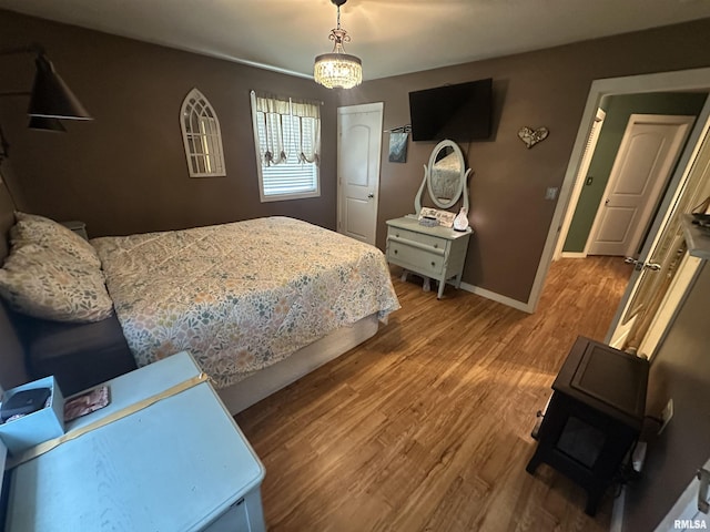 11382 Petroff Rd, Benton, IL 62812 - bedroom featuring a wood stove and wood finished floors