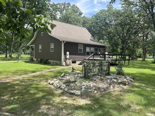 11382 Petroff Rd, Benton, IL 62812 - back of house featuring a yard, a wooden deck, and roof with shingles