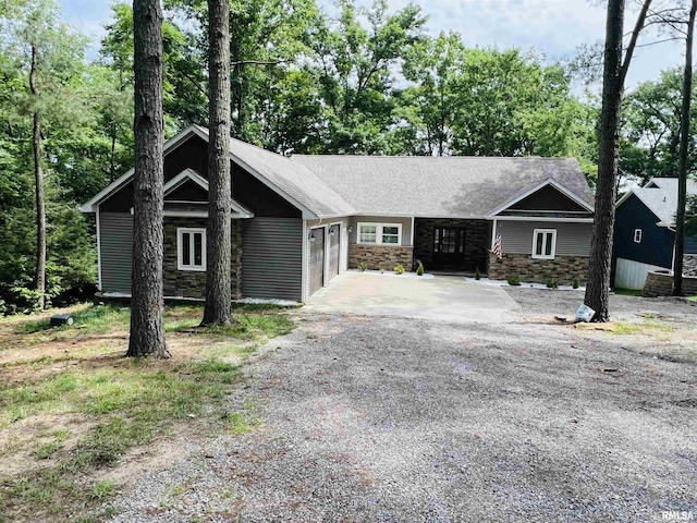65 Stony Pt, Goreville, IL 62939 - view of front of house with stone siding, a garage, and driveway