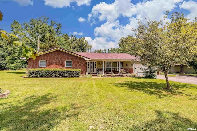 13399 S County Line Rd, West Frankfort, IL 62896 - single story home with covered porch, brick siding, driveway, a front yard, and a garage