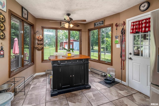 13399 S County Line Rd, West Frankfort, IL 62896 - sunroom with a baseboard radiator, a textured ceiling, and tile patterned flooring