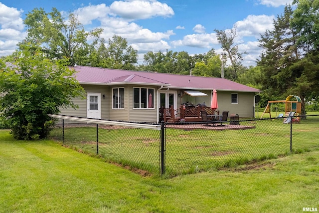 13399 S County Line Rd, West Frankfort, IL 62896 - back of property featuring a fenced backyard, a playground, and a metal roof