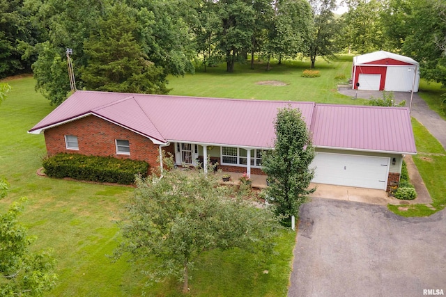 13399 S County Line Rd, West Frankfort, IL 62896 - view of front facade with a front yard, asphalt driveway, a metal roof, and a detached garage
