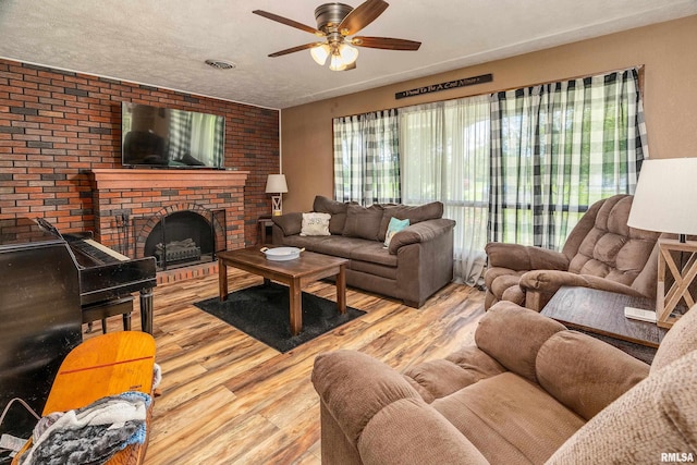 13399 S County Line Rd, West Frankfort, IL 62896 - living room with wood finished floors, a ceiling fan, and a brick fireplace
