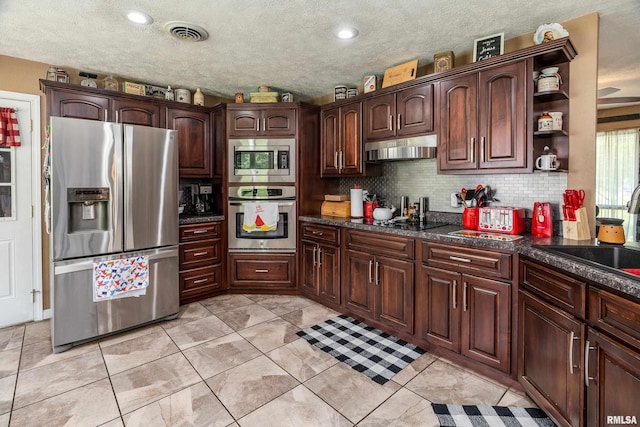 13399 S County Line Rd, West Frankfort, IL 62896 - kitchen with appliances with stainless steel finishes, under cabinet range hood, open shelves, backsplash, and dark brown cabinetry