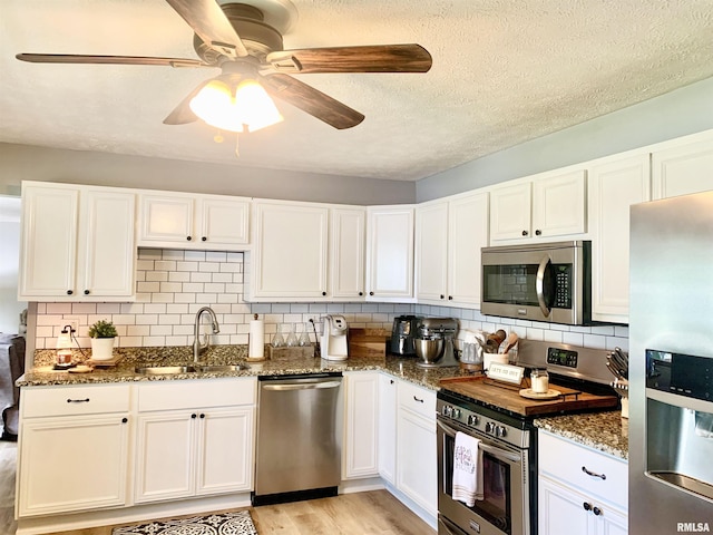 1203 W Goodall St, Marion, IL 62959 - kitchen with appliances with stainless steel finishes, dark stone counters, tasteful backsplash, and a ceiling fan