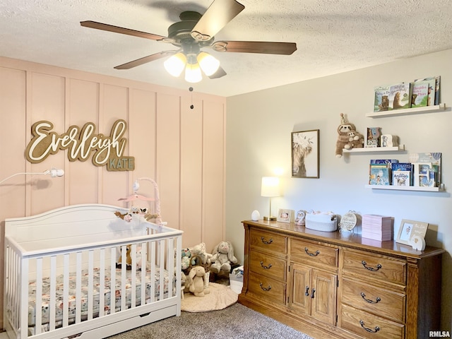 1203 W Goodall St, Marion, IL 62959 - bedroom featuring a crib, a textured ceiling, carpet, and a ceiling fan