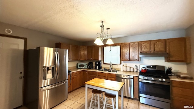 1409 Rig, Salem, IL 62881 - kitchen featuring appliances with stainless steel finishes, light countertops, light tile patterned flooring, decorative light fixtures, and under cabinet range hood