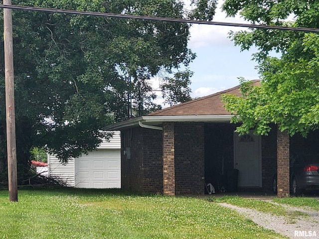 600 W Collins St, Goreville, IL 62939 - view of home's exterior with a yard, a garage, and brick siding