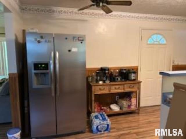 600 W Collins St, Goreville, IL 62939 - kitchen with stainless steel fridge, ceiling fan, wood finished floors, wainscoting, and ornamental molding