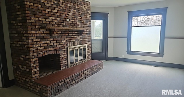 202 E 8th St, Mount Carmel, IL 62863 - unfurnished living room featuring a fireplace and carpet flooring