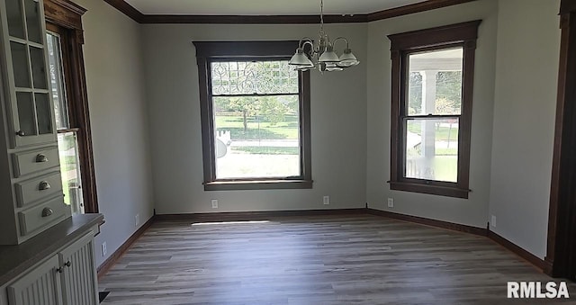 202 E 8th St, Mount Carmel, IL 62863 - empty room with a chandelier, crown molding, wood finished floors, and healthy amount of natural light