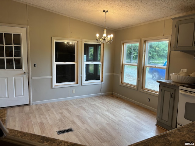 2780 Campground Rd, Anna, IL 62906 - unfurnished dining area with crown molding, lofted ceiling, a textured ceiling, a chandelier, and light wood-style floors
