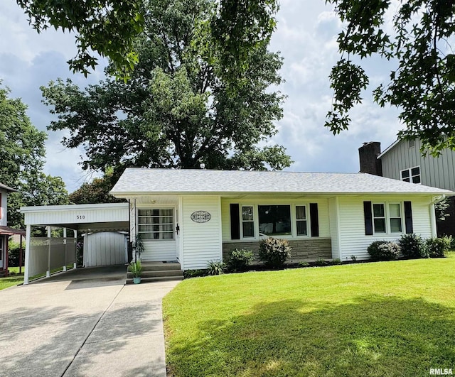 510 Morgan St, Anna, IL 62906 - view of front facade featuring driveway, a chimney, a front yard, stone siding, and a carport