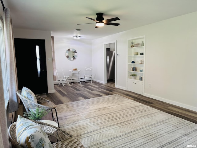 510 Morgan St, Anna, IL 62906 - living area featuring baseboard heating, wood finished floors, built in features, and ceiling fan
