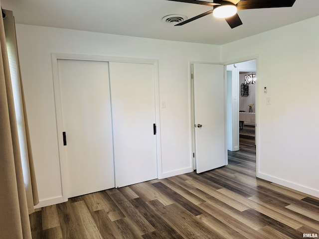510 Morgan St, Anna, IL 62906 - unfurnished bedroom with dark wood-style flooring, a closet, and a ceiling fan