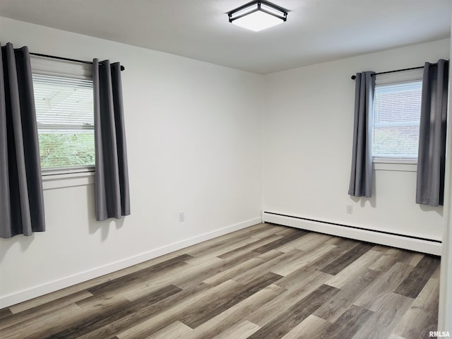 510 Morgan St, Anna, IL 62906 - empty room with a baseboard radiator, wood finished floors, and plenty of natural light