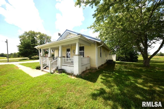 793 County Road 635 E, Wayne City, IL 62895 - view of front facade with a porch and a front lawn