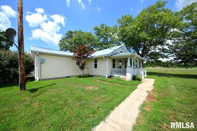 793 County Road 635 E, Wayne City, IL 62895 - view of front of home featuring a porch, a front yard, and a metal roof