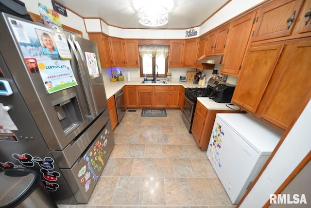 793 County Road 635 E, Wayne City, IL 62895 - kitchen with stainless steel appliances, under cabinet range hood, brown cabinetry, light countertops, and stone finish flooring