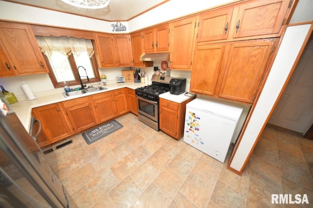793 County Road 635 E, Wayne City, IL 62895 - kitchen featuring gas stove, under cabinet range hood, fridge, light countertops, and stone finish flooring