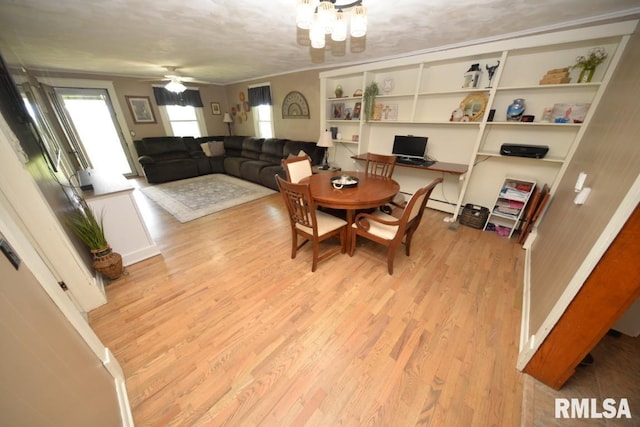 793 County Road 635 E, Wayne City, IL 62895 - dining space featuring wood finished floors, ceiling fan, a chandelier, an office area, and crown molding