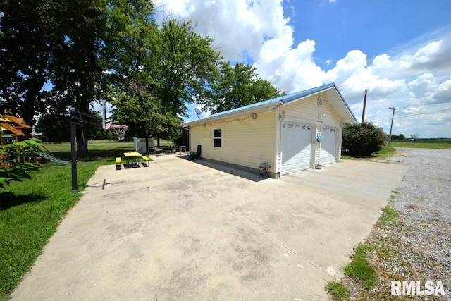 793 County Road 635 E, Wayne City, IL 62895 - view of side of property featuring an outdoor structure, a garage, and a lawn