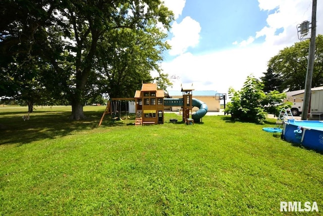 793 County Road 635 E, Wayne City, IL 62895 - view of green lawn featuring a playground and an outdoor pool