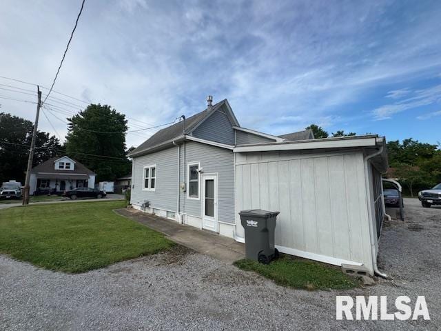 303 Elles Ave, Carterville, IL 62918 - view of property exterior featuring a lawn