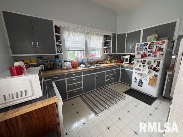 303 Elles Ave, Carterville, IL 62918 - kitchen featuring open shelves, white appliances, light floors, and gray cabinets