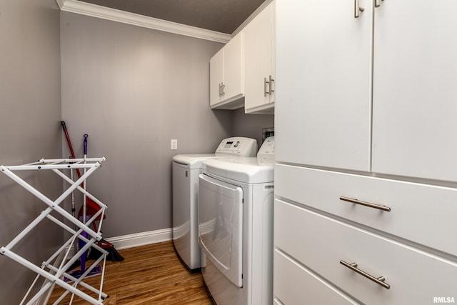 103 Woodland Trl, Anna, IL 62906 - laundry room featuring washing machine and clothes dryer, ornamental molding, cabinet space, and wood finished floors