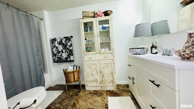 308 W Reed St, Benton, IL 62812 - bathroom with vanity, stone finish floors, and shower / bath combo
