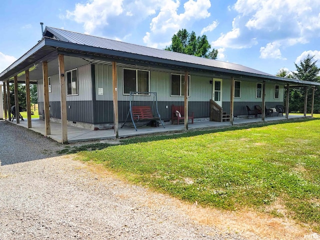232 Palm Ln, Flora, IL 62839 - view of front of house with a front lawn, a metal roof, and a patio