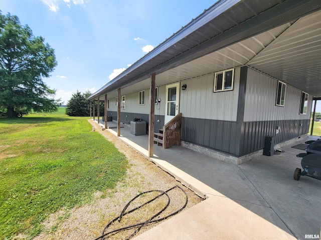 232 Palm Ln, Flora, IL 62839 - view of property exterior featuring a lawn and a central AC unit
