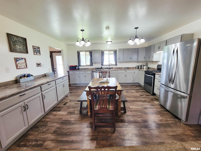 232 Palm Ln, Flora, IL 62839 - kitchen featuring stainless steel appliances, a chandelier, dark wood-type flooring, and decorative light fixtures
