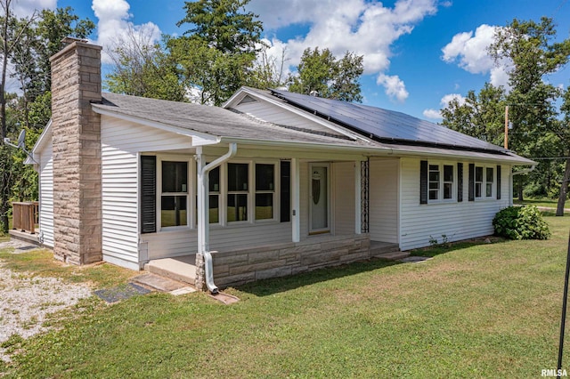 1471 Woods Ln, Centralia, IL 62801 - view of front of home with a front yard, a chimney, solar panels, and a shingled roof