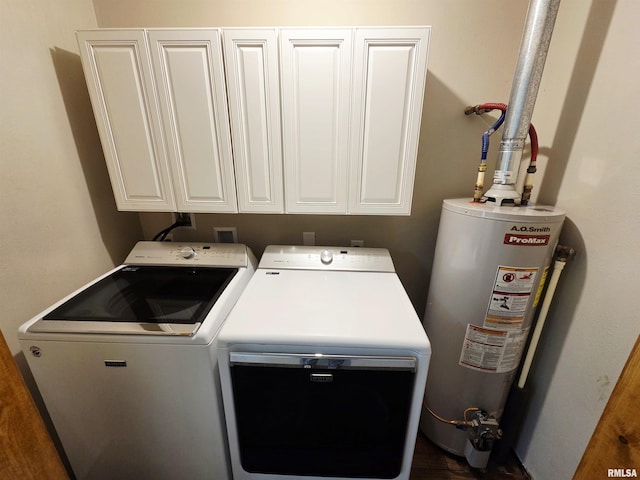 1471 Woods Ln, Centralia, IL 62801 - laundry room featuring washing machine and dryer, gas water heater, and cabinet space