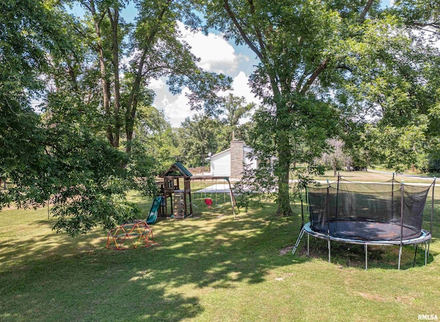 1471 Woods Ln, Centralia, IL 62801 - view of grassy yard with a trampoline, a playground, and view of wooded area