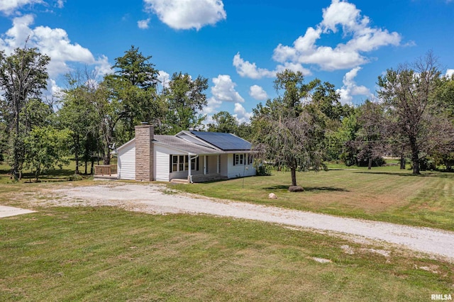 1471 Woods Ln, Centralia, IL 62801 - view of front of home with a chimney, roof mounted solar panels, a front yard, and dirt driveway