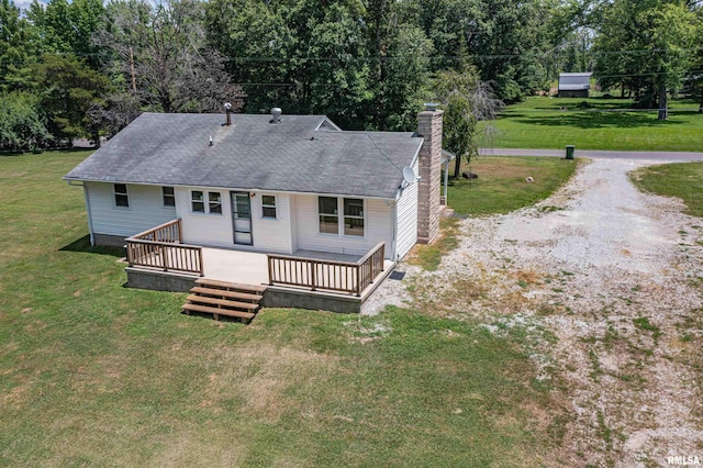 1471 Woods Ln, Centralia, IL 62801 - back of property featuring a chimney, a lawn, a deck, and roof with shingles