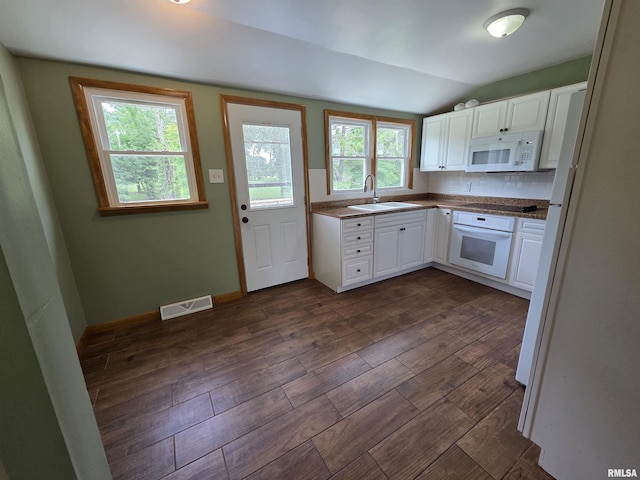 1471 Woods Ln, Centralia, IL 62801 - kitchen featuring white appliances, lofted ceiling, white cabinets, dark wood-type flooring, and dark countertops