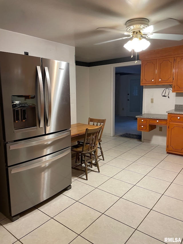 901 W Elm St, Carmi, IL 62821 - kitchen featuring stainless steel fridge with ice dispenser, ceiling fan, light tile patterned floors, brown cabinets, and a desk