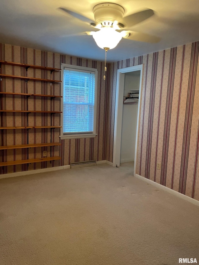 901 W Elm St, Carmi, IL 62821 - unfurnished room with wallpapered walls, carpet flooring, and ceiling fan