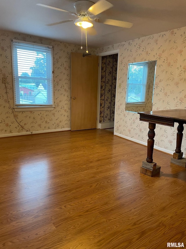 901 W Elm St, Carmi, IL 62821 - spare room featuring wood finished floors, ceiling fan, and wallpapered walls