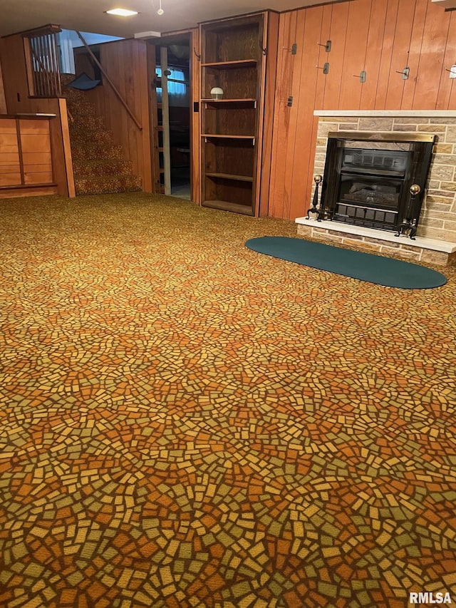 901 W Elm St, Carmi, IL 62821 - unfurnished living room featuring wooden walls, stairs, and a glass covered fireplace